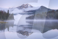 A misty Pyramid Mountain reflected in Pyramid Lake at dawn, Jasper National Park, Canadian Rockies, Alberta, Canada.Autumn 2015.
