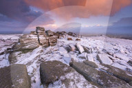 Colourful sunrise above snow covered moorland, Belstone Tor, Dartmoor, Devon, England. Winter (January) 2016.