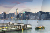 View of Star Ferry Terminal and Hong Kong Island skyline at dusk, Hong Kong, China