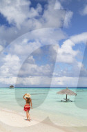 Woman walking on beach, Fakarava, Tuamotu Islands, French Polynesia (MR)