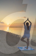 Woman practicing yoga at sunrise, Rasdhoo Island, Northern Ari Atoll, Maldives (MR)