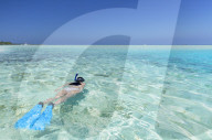 Woman snorkelling in lagoon, Rasdhoo Island, Northern Ari Atoll, Maldives (MR)
