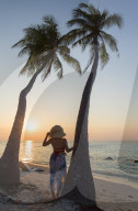 Woman on beach at sunset, Maafushi Island, Kaafu Atoll, Maldives (MR)