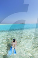 Woman snorkelling in lagoon, Rasdhoo Island, Northern Ari Atoll, Maldives (MR)