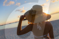 Woman on beach at Olhuveli Beach and Spa Resort, South Male Atoll, Kaafu Atoll, Maldives (PR + MR)