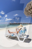 Woman on beach at Olhuveli Beach and Spa Resort, South Male Atoll, Kaafu Atoll, Maldives (PR + MR)