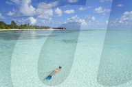 Woman snorkelling at Olhuveli Beach and Spa Resort, South Male Atoll, Kaafu Atoll, Maldives (PR + MR)