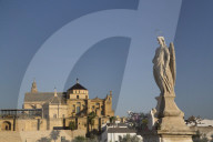 Statue of Raphael the Archangel (foreground), The Great Mosque (Mosquita) and Cathedral (background), Cordoba, Spain