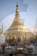 Candles placed by devotees at sunset in front of the golden Shwesagon Pagoda, a 2,500 year old Buddhist pilgrimage site, Yangon.