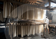 Sheets of freshly cooked rice sheets hanging on bamboo poles to be shredded into rice noodles and dried, Hsipaw, Shan state.