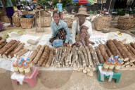 Women selling thanaka sticks, to be ground into paste to wear on the face as a decorative and protective mask, Sagaing Division.