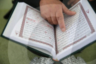 Man reading the Quran in a mosque.