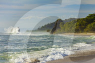Surf breaking on sea stack & the 'Penon' rock at this far south  Nicoya Peninsula beach; Santa Teresa, Puntarenas, Costa Rica