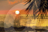 Sun going down behind surf spray at this resort near Mal Pais, southern Nicoya Peninsula; Santa Teresa, Puntarenas, Costa Rica