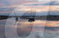 A beautiful sunset at low tide at Brancaster Staithe, Norfolk, England.