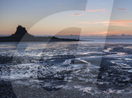 A view across the Ouse to Lindisfarne Castle, Holy Island, Northumberland, England.
