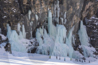 Skiers underneath the frozen waterfall, Hidden valley ski area, Lagazuoi, Armentarola 101, Ski piste,  Dolomites, UNESCO world heritage site Dolomites, South Tyrol, Italy.