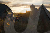 A camper sits in the evening sun, Picws Du, Black Mountain, Brecon Beacons National Park, Wales, United Kingdom