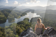 Tourist on top of Bukit Tabur Mountain overlooking Klang Gates Dam, Kuala Lumpur, Malaysia