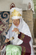 Kazakh woman spinning wool, Kazakh ethnographical village Aul Gunny, Talgar city, Almaty, Kazakhstan, Central Asia, Asia