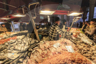 Busy fish stall with many customers and huge array of fish, Pescheria, Rialto Markets, Venice, UNESCO Site, Winter, Italy