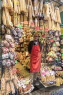 Grocery store owner proudly stands at shop front with pasta, City of Naples Historic Centre, UNESCO World Heritage Site, Italy