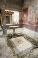 Impluvium, with table and drum, House of (Casa di) Fabius Amandius, Roman Pompeii, UNESCO World Heritage Site, Campania, Italy