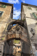 Old Town (Stari Grad), arch way with relief and hanging washing in an alley, Kotor, UNESCO World Heritage Site, Montenegro