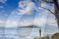 Woman looking out over the Magellan straits and Darwin mountain range in Tierra del Fuego national park