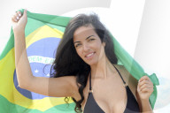 Young Brazilian woman 20-29 years old holding the Brazilian flag on a beach in Rio de Janeiro