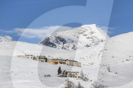 The snowy huts frame Peak Tambo in the background, Andossi, Spluga Valley, Province of Sondrio, Valtellina, Lombardy, Italy, Europe