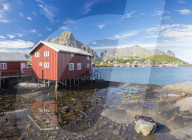 Typical house of fishermen called Rorbu reflected in blue sea, Reine, Moskenesoya, Lofoten Islands, Norway, Scandinavia, Europe