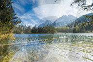 Lake Weissensee surrounded by woods with the Alps in the background Biberwier Carinthia Tyrol Austria Europe