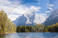 Lake Weissensee surrounded by woods with the Alps in the background Biberwier Carinthia Tyrol Austria Europe