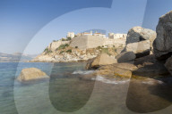 The old fortified citadel on the promontory surrounded by the clear sea Calvi Balagne Region northwest Corsica France Europe