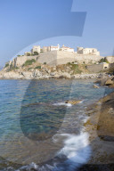 The old fortified citadel on the promontory surrounded by the clear sea Calvi Balagne Region northwest Corsica France Europe