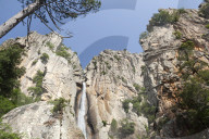 Blue sky frames The Piscia di Gallo waterfall surrounded by granite rocks Zonza Southern Corsica France Europe