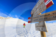 Hiker with snowshoe proceeds on the path covered with snow Braulio Valley Valtellina Lombardy Italy Europe