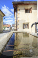 Fountain in the alleys of the alpine village Guarda canton of GraubÃ¼nden Inn District Lower Engadine Switzerland Europe