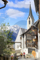 Bicycles in the old town framed by snowy peaks Guarda canton of GraubÃ¼nden Inn District Lower Engadine Switzerland Europe