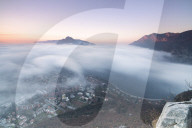 Fog at sunrise above the city of Lecco seen from Monte San Martino Province of Lecco Lombardy Italy Europe