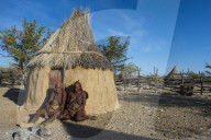 Himba women in front of their hut, Kaokoland, Namibia