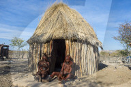 Himba women in front of their hut, Kaokoland, Namibia