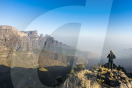 Woman enjoying the early morning sun on the cliffs, world heritage sight, Simien mountains national park, Debarq, Ethiopia