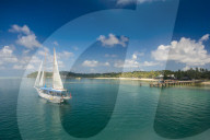 Sailing boat anchoring on Mana island, Mamanuca islands, Fiji