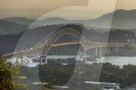 Cargo boat passes the Bridge of the Americas on the Panama canal, Panama City, Panama
