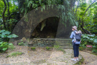 Woman with a baby hiking in the Unesco world heritage sight, Sacred site Sefa Utaki, Okinawa, Japan