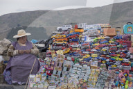 Traditional miniature cars and money thought to give good luck for sale at a stall in the resort of Copacabana on Lake Titicaca,