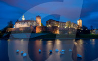 Wawel Hill Castle and Cathedral, Vistula River with swans, illuminated at night, Krakow, Poland