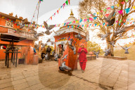 Woman walking and praying with pigeons at the hilltop temple